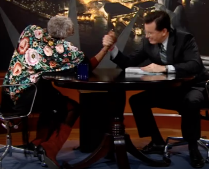 Nell Painter arm-wrestling Stephen Colbert image of Nell Painter arm-wrestling Stephen Colbert